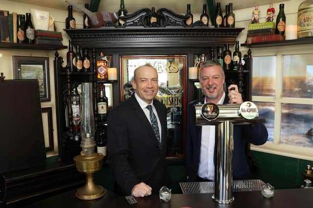 Portadown-based themed-interiors specialist, The Deluxe Group, launches a new mini Irish pub into the US leisure market The Deluxe Group's First Pub Óg delivery coincides with the launch of its new Orlando base and a $750,000 investment. Pictured is The Secretary of State for Northern Ireland, Chris Heaton-Harris during a recent visit and Colm O’Farrell, executive chairman, The Deluxe Group