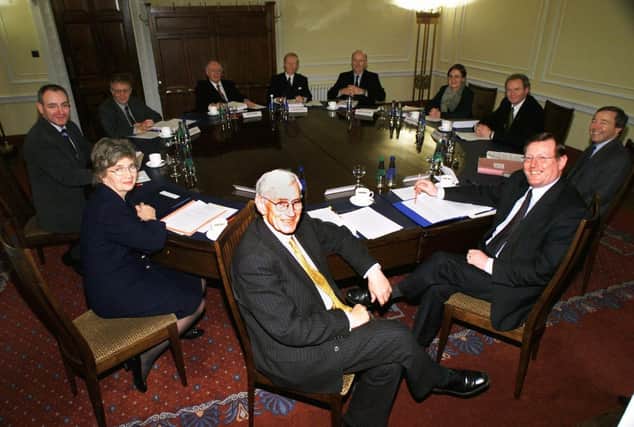 Northern ireland's new power-sharing executive met in December 1999 for the first time, then dominated by the Ulster Unionists and SDLP. Seated from clockwise at front, SDLP leaders Seamus Mallon, Brid Rodgers, Mark Durkan and Sean Farren. The Ulster Unionists Sam Foster, Sir Reg Empey and Michael McGimpsey. Sinn Fein's Barbara De Brun and Martin McGuinness with Cabinet Secretary John Semple and First Minister David Trimble. Missing are Ministers Nigel Dodds and Peter Robinson of the DUP, who were refusing to sit in cabinet with Sinn Fein. (Photo Paul FAITH/AFP via Getty Images)