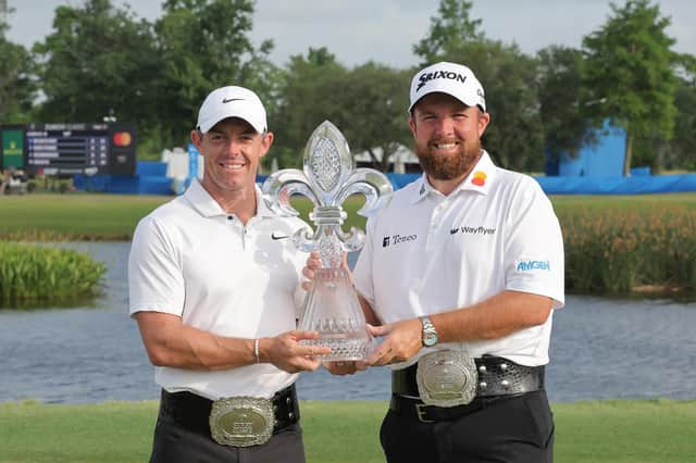 Rory McIlroy (left) and Shane Lowry pose with the Zurich Classic of New Orleans trophy following a first-hole playoff win at TPC Louisiana. (Photo by Jonathan Bachman/Getty Images)