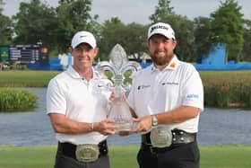 Rory McIlroy (left) and Shane Lowry pose with the Zurich Classic of New Orleans trophy following a first-hole playoff win at TPC Louisiana. (Photo by Jonathan Bachman/Getty Images)