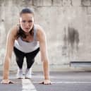 A woman performing the much-maligned burpee exercise move which is apparently excellent for losing weight