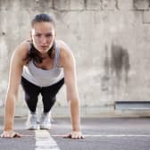 A woman performing the much-maligned burpee exercise move which is apparently excellent for losing weight