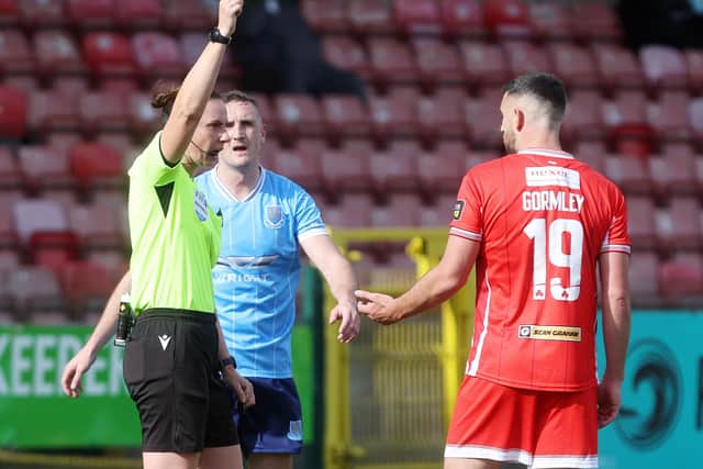 Referee Louise Thompson shows Cliftonville’s Joe Gormley a yellow card. (Photo by INPHO/Jonathan Porter)