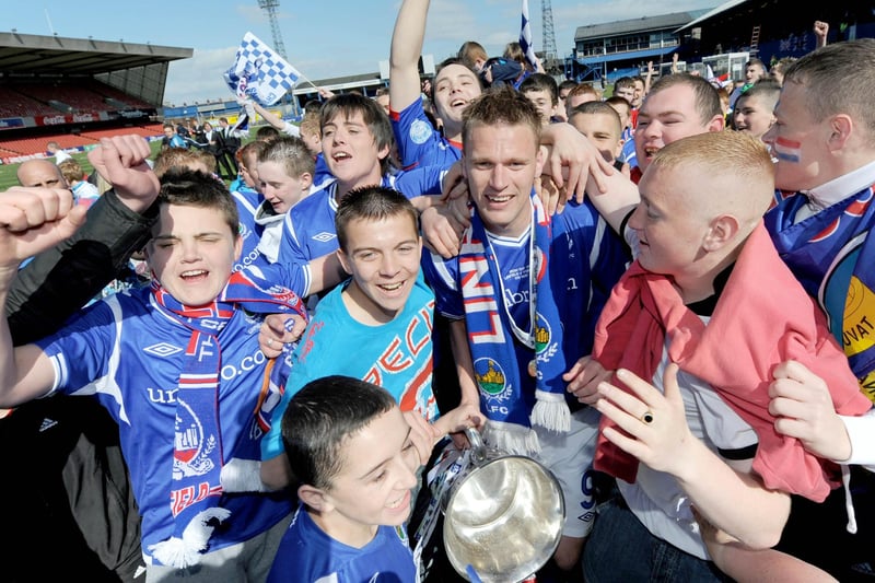 Linfield goalscorer Peter Thompson gets mobbed by the crowd
