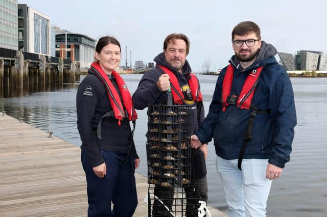 Rachel Millar, Marine Conservation Officer, Ulster Wildlife; Dr Dave Smyth, Marine Conservation Manager, Ulster Wildlife and Simon Gibson, Marine, Environment & Biodiversity Officer, Belfast Harbour. An oyster nursery has been installed in Belfast Harbour in a bid to improve water quality and boost marine life.  Photo: Belfast Harbour/PA Wire
