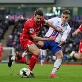 Joel Cooper and Portadown’s Gary Thompson in action at Windsor Park