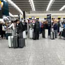 File photo dated 31/03/23 of passengers wait in line to at Terminal 5 of Heathrow Airport, London. A planned relaxation of rules around airline passengers carrying liquids in hand luggage has been delayed by a year.