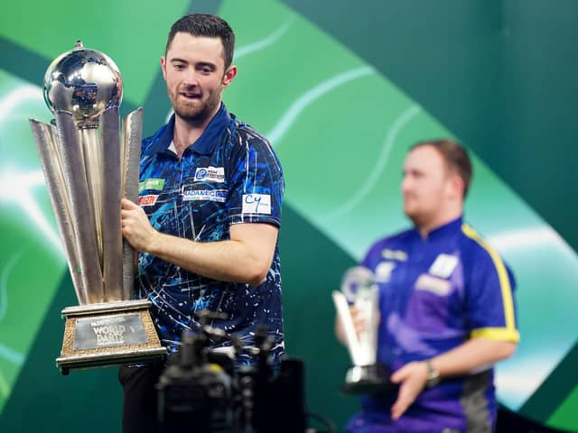 Luke Humphries celebrates with the trophy after beating Luke Littler in the final of the World Darts Championship at Alexandra Palace, London
