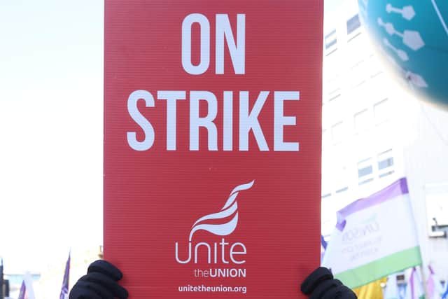 A Unite member taking part in the strike at Belfast City Hall on 18 January. Photo: Liam McBurney/PA Wire
