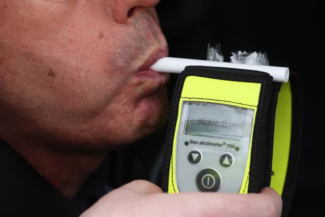 A driver blows into a breathalyser at the launch of the 2022/23 police winter anti-drink/drug drive operation on Sydenham Road in Belfast. Picture date: Thursday December 1, 2022. PA Photo. See PA story ULSTER Police. Photo credit should read: Liam McBurney/PA Wire