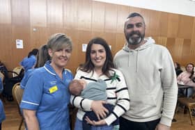 Mum Rachel, dad Mark and baby Jude alongside CoMC midwife Grace.