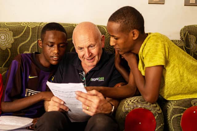 Debiyso, the very first child rescued by Hope365, is studying hard and aiming for third level education.  He is pictured last year showing course work to Hope365 Chief Executive Michael Holmes.  Photo: Michael Holmes