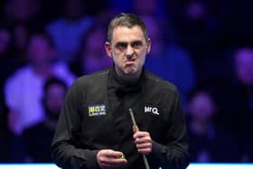 Ronnie O'Sullivan is through to the quarter-final of the World Grand Prix after edging out Zhou Yuelong in Leicester