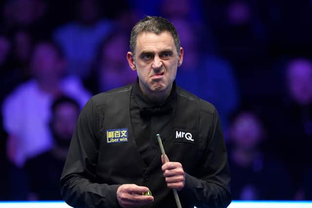 Ronnie O'Sullivan is through to the quarter-final of the World Grand Prix after edging out Zhou Yuelong in Leicester