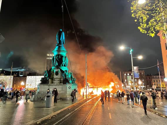 A bus and car on fire on O'Connell Street in Dublin city centre after violent scenes unfolded following an attack on Parnell Square East where five people were injured, including three young children