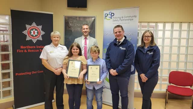Chloe and Adam Sproule from Kesh, County Fermanagh being awarded for their bravery