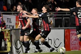 Philip Lowry (left) celebrates scoring for Crusaders over Linfield