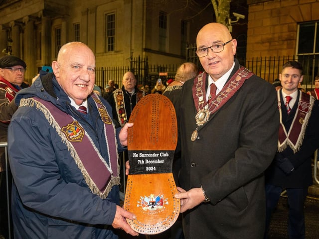 Philip Gillen from the No Surrender Club is presented with the commemorative shoe by Governor William Walker before the burning of the effigy of Lundy.