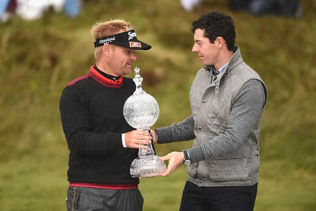 Soren Kjeldsen receives the 2015 Irish Open trophy from Northern Ireland's Rory McIlroy at Royal County Down Golf Club. (Photo by Ross Kinnaird/Getty Images)