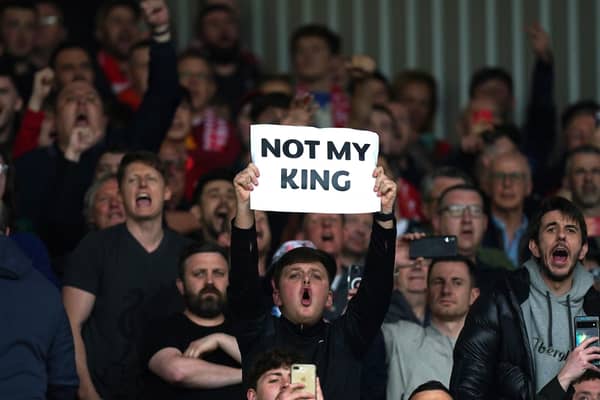 Liverpool fans hold up a sign saying 'Not My King' while booing the national anthem before the Premier League match at Anfield, Liverpool. : Saturday May 6, 2023.