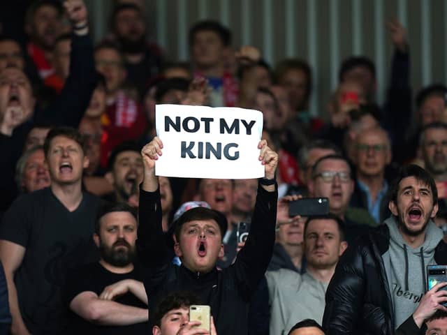 Liverpool fans hold up a sign saying 'Not My King' while booing the national anthem before the Premier League match at Anfield, Liverpool. : Saturday May 6, 2023.