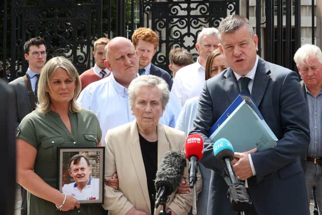 The widow of murdered GAA official Sean Brown, Bridie Brown (centre) stands with her son and daughter Clare Loughran (left) and Sean (second left) as Niall Murphy, family solicitor from KRW Law, speaks to the media, outside the Royal Courts of Justice in Belfast