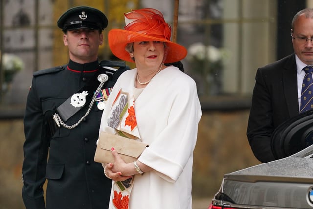Former prime minister Theresa May  wore a white and orange hat
