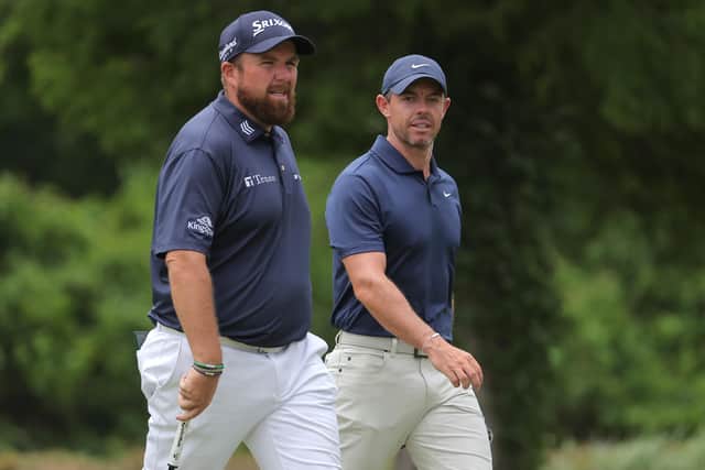 Shane Lowry of Ireland and Northern Ireland's Rory McIlroy walk on the fifth hole during the third round of the Zurich Classic of New Orleans at TPC Louisiana