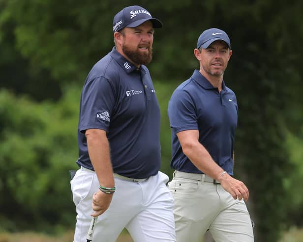 Shane Lowry of Ireland and Northern Ireland's Rory McIlroy walk on the fifth hole during the third round of the Zurich Classic of New Orleans at TPC Louisiana