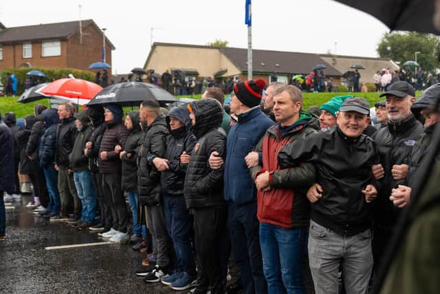 Protesters link arms as they block the Garvaghy Road as they faced the PSNI line on Sunday 27 September. Picture: Ronan McGrade