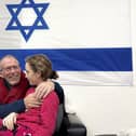 In this photo provided by the Israeli Army, Emily Hand, a released hostage, reunites with her father on Sunday