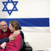 In this photo provided by the Israeli Army, Emily Hand, a released hostage, reunites with her father on Sunday