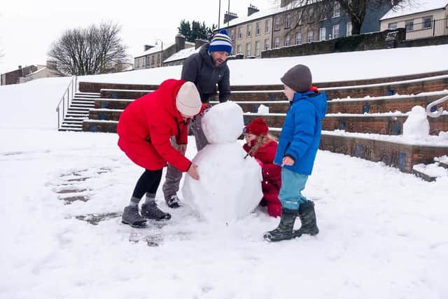 The Regan family making a snowman in Enniskillen on 1 March 2024. Photo: Andrew Paton/PressEye