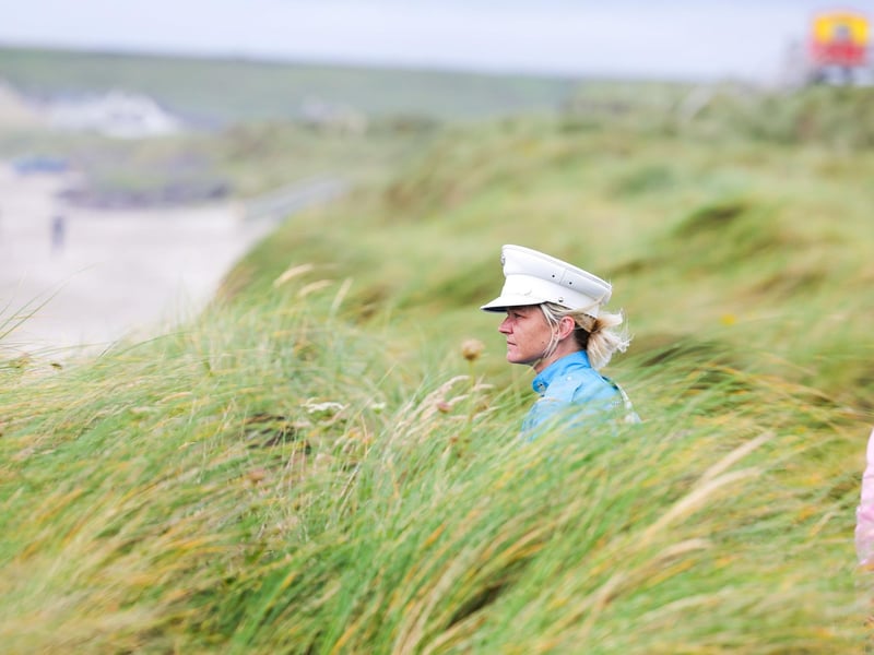 A bands woman pictured in the dunes of the beach
