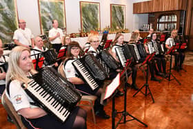 Aughafatten Accordion Band from Broughshane, led by Moira McKee, on the stage ready to play at the festival.