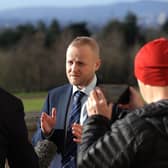 Jamie Bryson speaks to the media today outside the Parliament Buildings in Stormont, Belfast