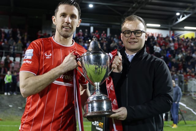 Portadown captain Gary Thompson is presented with the trophy by Darren McPolin from Player-Fit