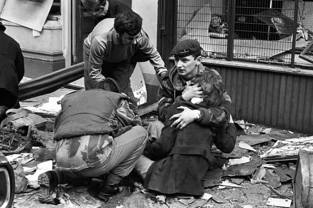 A soldier comforts a girl after the 1972 IRA bomb blast at the News Letter in Donegall Street, Belfast in which seven people were murdered. A compensation scheme would reinforce the idea that there was no alternative to over 3,500 deaths