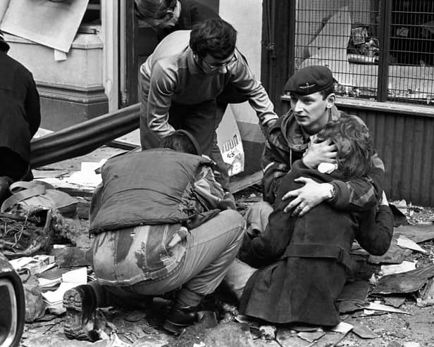 A soldier comforts a girl after the 1972 IRA bomb blast at the News Letter in Donegall Street, Belfast in which seven people were murdered. A compensation scheme would reinforce the idea that there was no alternative to over 3,500 deaths