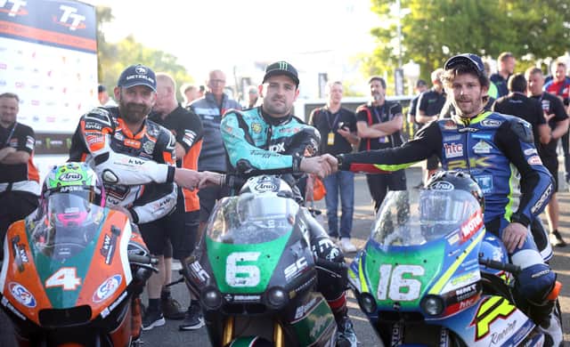 Michael Dunlop (MD Racing/SC Project Paton) celebrates winning his 24th TT in the first Supertwin race with runner-up Mike Browne (Burrows Engineering/RK Racing Paton) and third-placed Jamie Coward (KTS Racing/Steadplan Kawasaki)