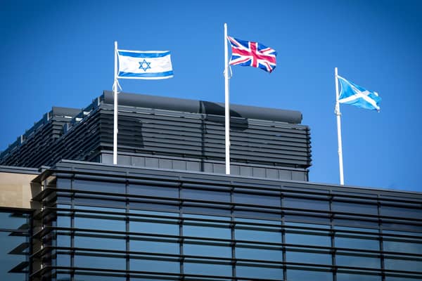 The flag of Israel, the Union flag and the Saltire fly above the UK Government Queen Elizabeth House building in Edinburgh. Picture date: Friday October 13, 2023. PA Photo. Photo credit should read: Jane Barlow/PA Wire 