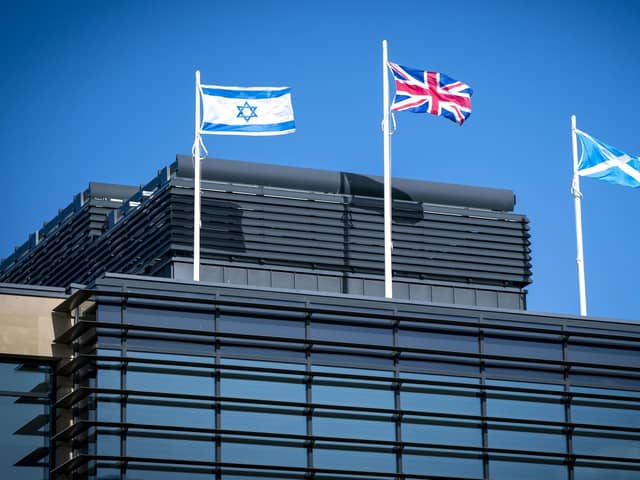 The flag of Israel, the Union flag and the Saltire fly above the UK Government Queen Elizabeth House building in Edinburgh. Picture date: Friday October 13, 2023. PA Photo. Photo credit should read: Jane Barlow/PA Wire 
