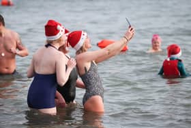 Swimmers from north Down take part in the annual Santa Splash at Helens Bay beach, County Down. 
The Helens Baywatch swimmers group organised the event in aid of the RLNI and Marie Curie Hospice.