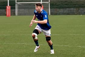 Joe Hopes in action for Queen's against Old Wesley