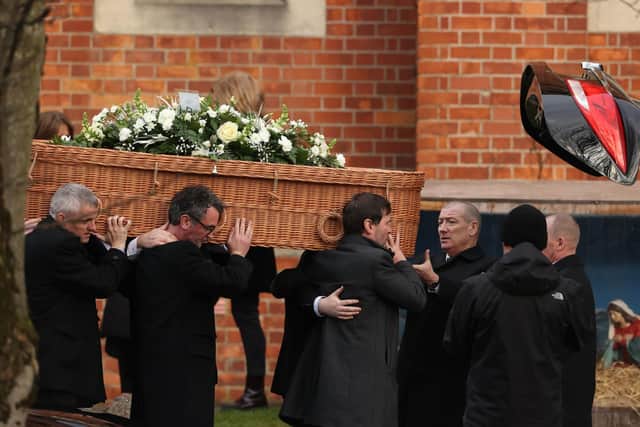 The coffin of former Press Association journalist Brian Hutton leaves St Patrick's Roman Catholic Church in Londonderry
