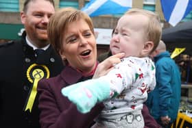 File photo dated 4/12/2019 of SNP leader Nicola Sturgeon holding a baby in Dalkeith