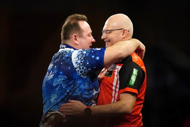 Brendan Dolan reacts after his match against Mickey Mansell (right) on day eight of the Paddy Power World Darts Championship at Alexandra Palace, London. PIC: Zac Goodwin/PA Wire.