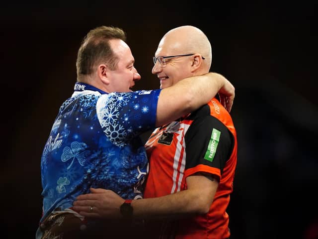 Brendan Dolan reacts after his match against Mickey Mansell (right) on day eight of the Paddy Power World Darts Championship at Alexandra Palace, London. PIC: Zac Goodwin/PA Wire.
