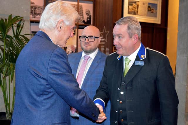 Bill Clinton is welcomed to the Europa Hotel by head concierge Martin Mulholland as general manager Andy McNeill looks on