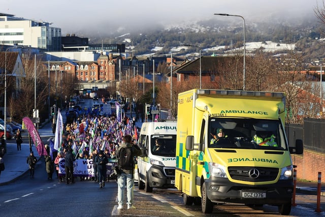 Ambulances drive ahead of a parade of public sector workers from Unison joined by other public sector workers walk from the picket line at the Royal Victoria Hospital to a rally at Belfast City Hall, as an estimated 150,000 workers take part in walkouts over pay across Northern Ireland.
